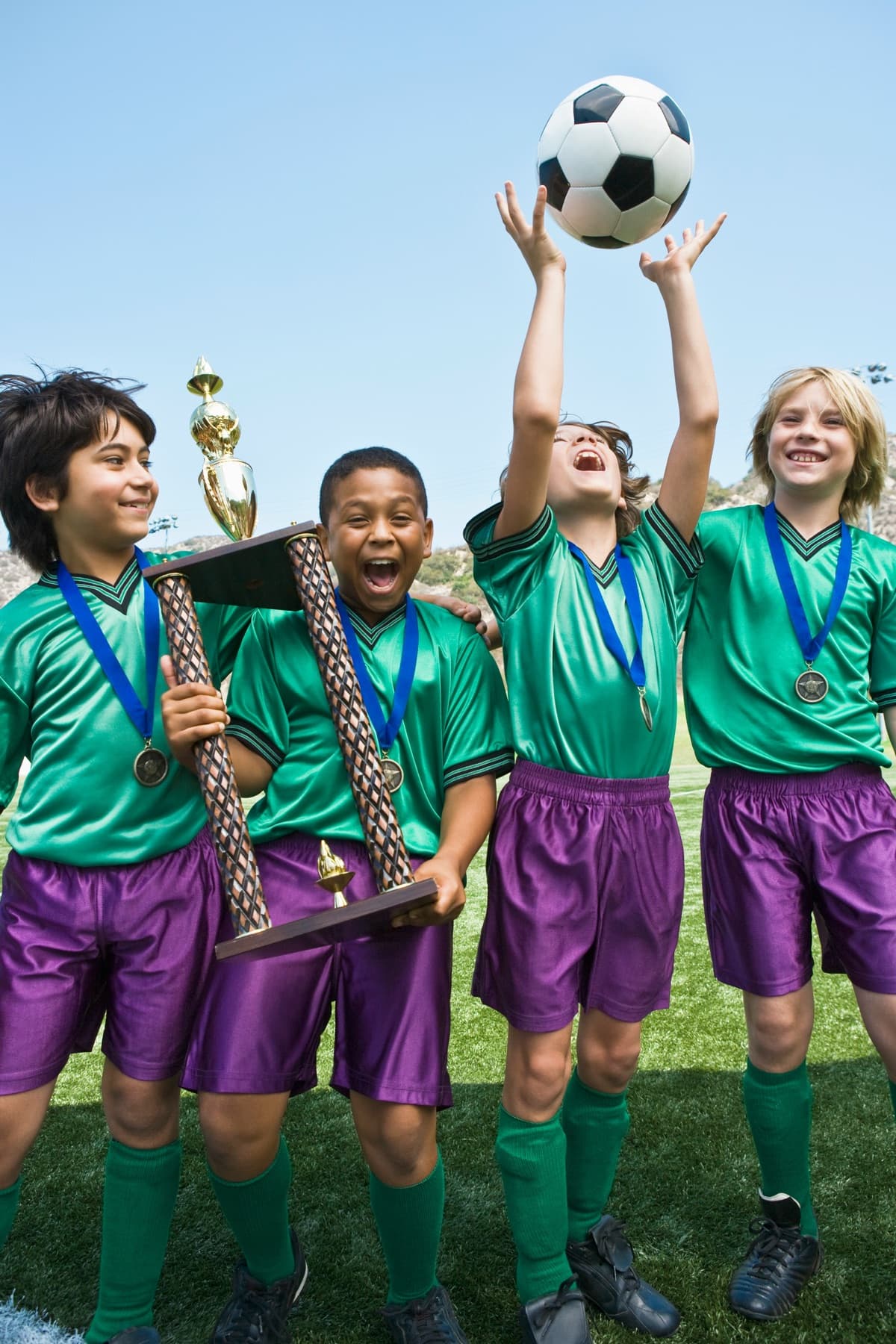 A children's football team celebrating with a trophy